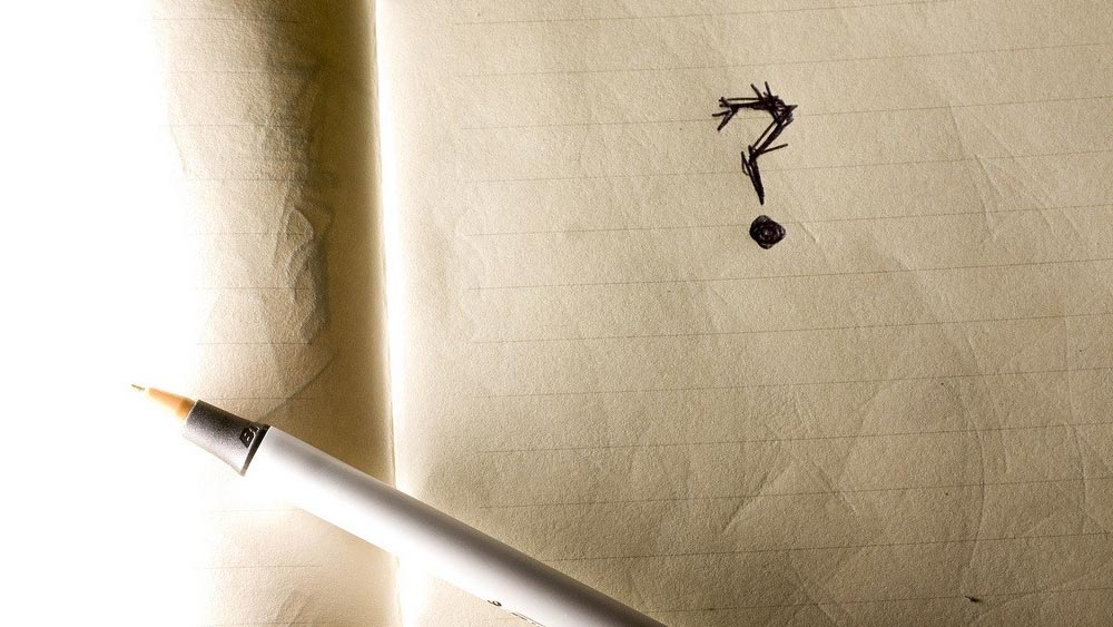 11 Questions You Should Always Ask App Development Companies A question mark written in a notebook, asking a question