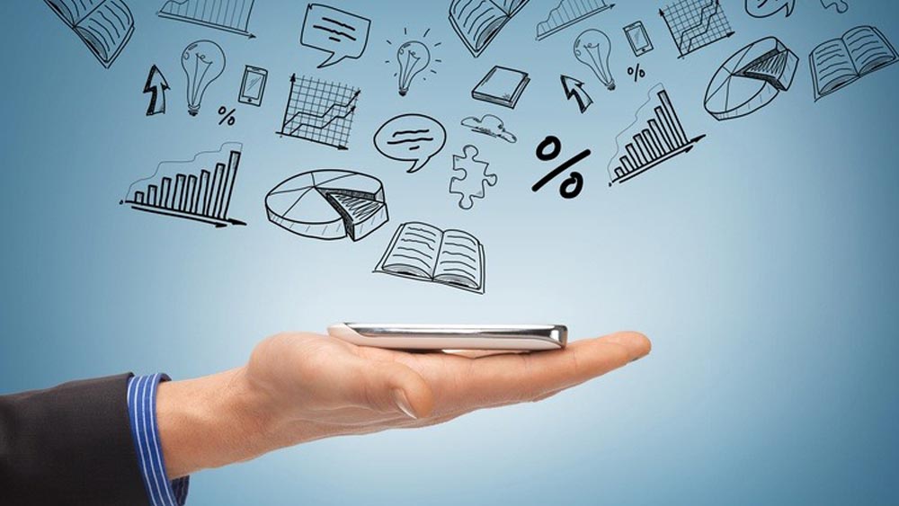 9 Tips for Managing Cross-Platform Mobile App Development Hand holding mobile device with misc app icons around