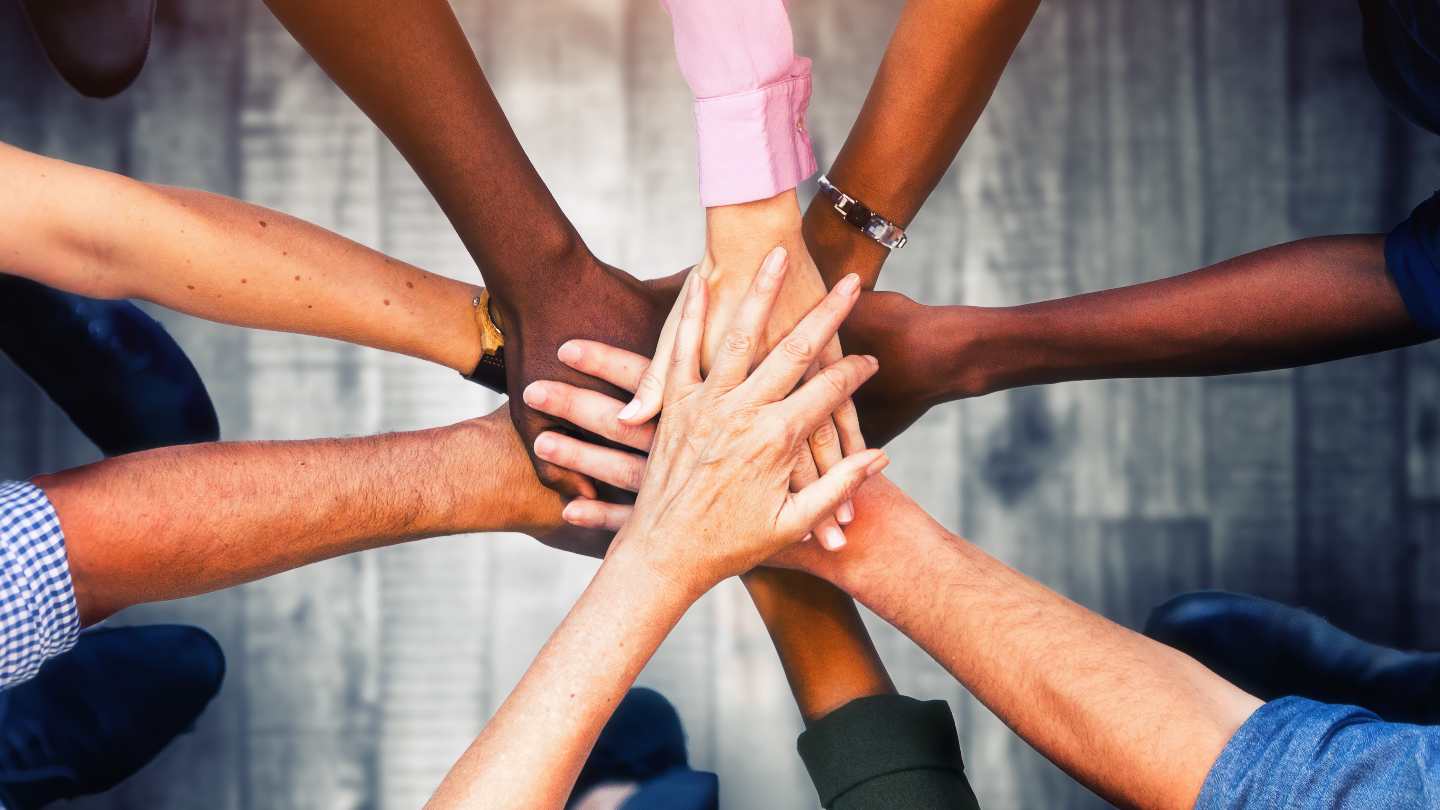 Agile-Way-Trust-your-Talent-Article Team who practices agile scrum with their hands together