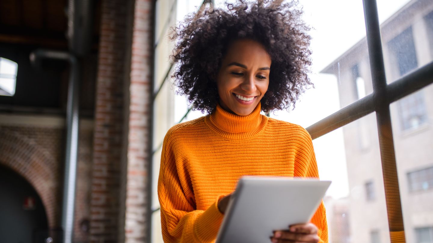 Woman enjoying using a tablet