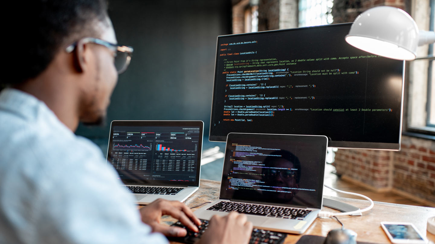 Agile-methodology-facilitates-innovation Male developer coding on several screens