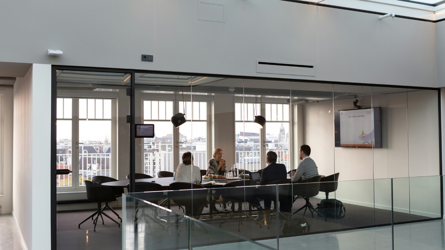 A meeting being held in open concept office.