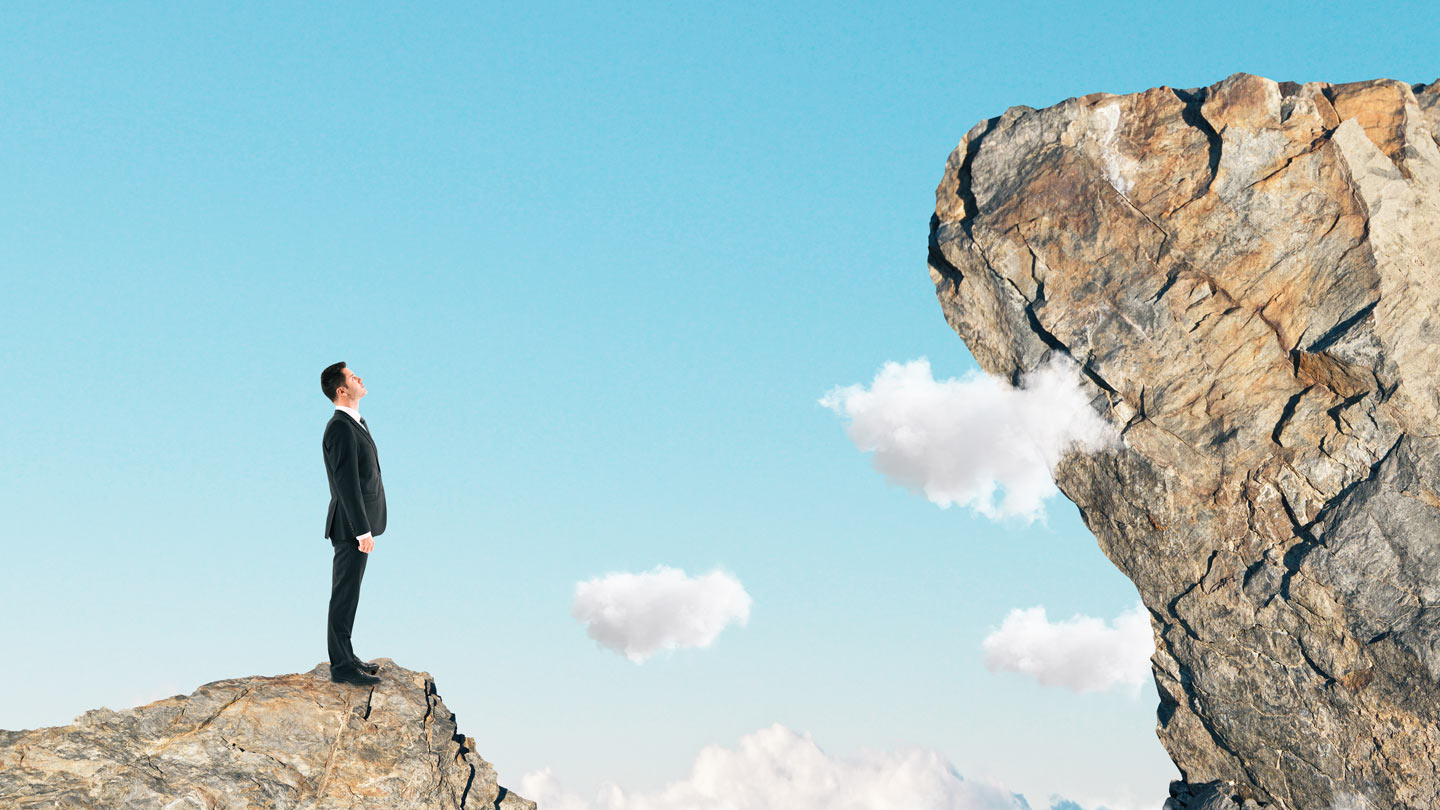moving-to-the-cloud Move to the cloud man looking at rock with clouds