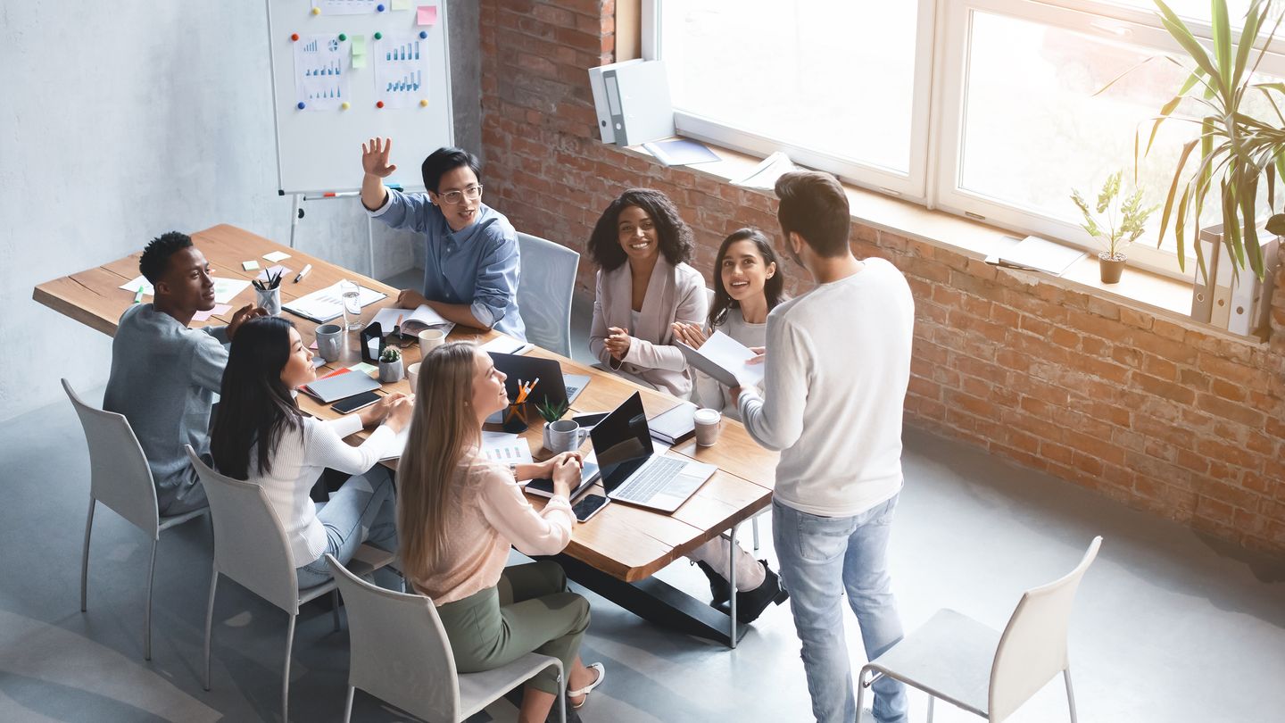 Diverse team holding a communities of practice meeting