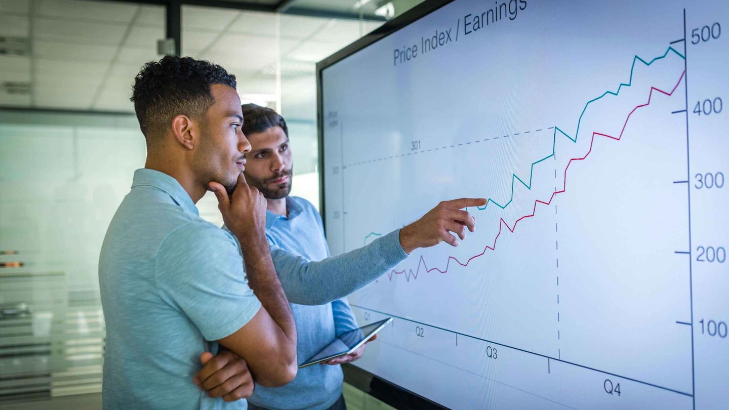 Increasing Your Firm’s Value with Software: Expand Your Value Proposition with an App Two men discuss firm's value on digital chart