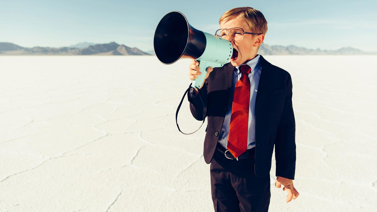 What Happens After Your Minimum Viable Product is Completed? Boy in suit talking into megaphone