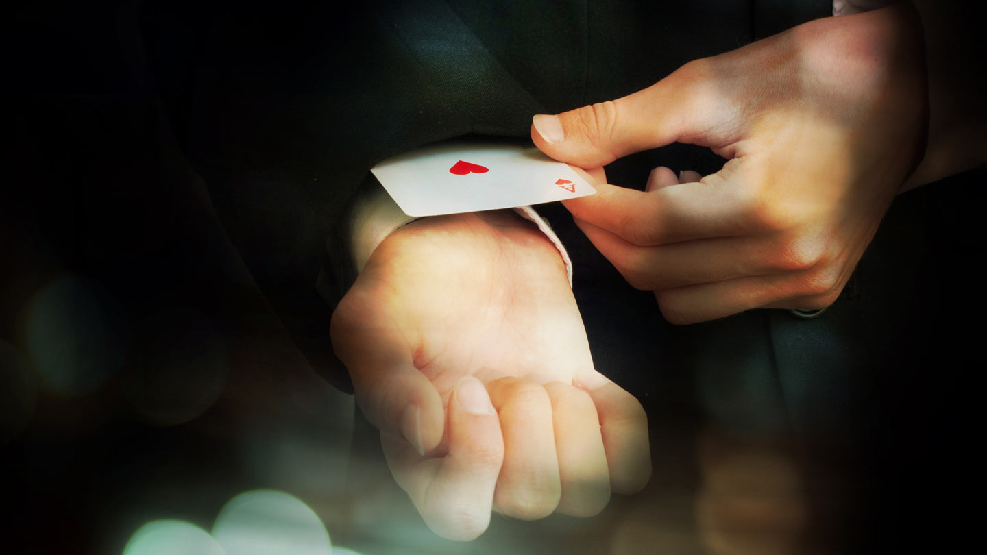 Ace up the sleeve Photo of man pulling an ace of hearts out of sleeve